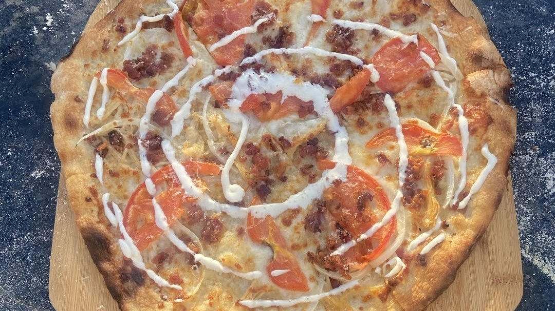 Chicken bacon ranch pizza with ranch drizzle