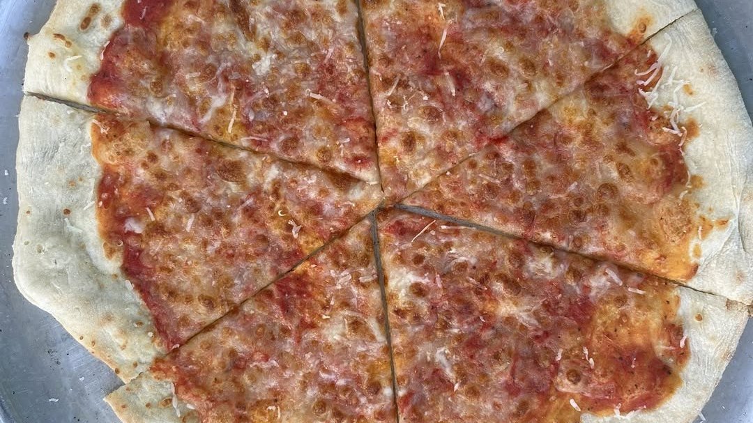 A simple cheese wood-fired pizza, charred and bubbling